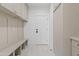 A practical mudroom with coat rack, storage cabinets, and an exterior door at 24645 N 117Th St, Scottsdale, AZ 85255