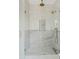 A glass-enclosed shower features a rain shower head, marble accents, and custom fixtures at 24645 N 117Th St, Scottsdale, AZ 85255