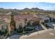 Stunning aerial view showcasing this single-story home's tile roof and landscaped front yard, set against a mountain backdrop at 25971 W Taro Dr, Buckeye, AZ 85396