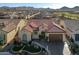Expansive aerial view captures the tile roof, desert landscaping, and golf course community surrounding this charming single-story home at 25971 W Taro Dr, Buckeye, AZ 85396