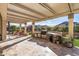 Large outdoor kitchen area with a built-in grill and backyard views at 25971 W Taro Dr, Buckeye, AZ 85396