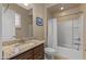 Bathroom featuring granite countertops, and a shower-tub combo with white tiled walls at 25971 W Taro Dr, Buckeye, AZ 85396