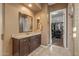 Bathroom featuring granite countertops, undermount sink, and access to walk-in closet at 25971 W Taro Dr, Buckeye, AZ 85396