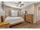 Bedroom with hardwood floors, window shutters, and wooden furniture at 25971 W Taro Dr, Buckeye, AZ 85396