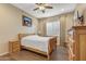 Bedroom with wooden bed frame, hardwood floors, and a ceiling fan at 25971 W Taro Dr, Buckeye, AZ 85396