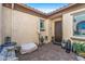 Private courtyard with brick pavers, comfortable seating, various patio accessories, and stylish outdoor decor at 25971 W Taro Dr, Buckeye, AZ 85396