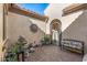 Charming courtyard with brick flooring, water feature, and decorative sunburst art at 25971 W Taro Dr, Buckeye, AZ 85396