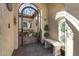 Private courtyard featuring an ornate metal gate, potted plants, garden art, and an elegant stone bench at 25971 W Taro Dr, Buckeye, AZ 85396