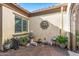 Private courtyard with brick pavers, a decorative fountain, garden art, and potted plants at 25971 W Taro Dr, Buckeye, AZ 85396