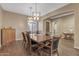 Dining room with wooden table, chairs, and modern light fixture at 25971 W Taro Dr, Buckeye, AZ 85396