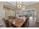 Dining room with hardwood floors, stylish lighting, and open layout to living areas at 25971 W Taro Dr, Buckeye, AZ 85396