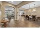 Open-concept dining room with hardwood floors and modern chandelier lighting at 25971 W Taro Dr, Buckeye, AZ 85396
