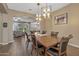 Open dining room with hardwood floors, stylish lighting, and view to living area at 25971 W Taro Dr, Buckeye, AZ 85396