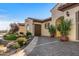 Inviting driveway leading to an arched entry with an enclosed courtyard with a two car garage on the left side at 25971 W Taro Dr, Buckeye, AZ 85396