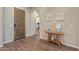 Inviting entryway with hardwood floors, wooden door and neutral decor at 25971 W Taro Dr, Buckeye, AZ 85396