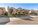 Charming single-story home showcasing professional desert landscaping with a clay tile roof and attached two-car garage at 25971 W Taro Dr, Buckeye, AZ 85396