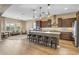 Open kitchen with dark cabinets, granite counters, island with seating, and hardwood floors at 25971 W Taro Dr, Buckeye, AZ 85396