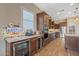Gourmet kitchen with wine fridge, granite counters, stainless appliances, and ample cabinet storage at 25971 W Taro Dr, Buckeye, AZ 85396