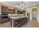 Kitchen with large island with seating, stainless appliances, and dark cabinetry at 25971 W Taro Dr, Buckeye, AZ 85396