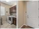 Functional laundry room with washer, dryer, sink, and ample storage, enhancing convenience at 25971 W Taro Dr, Buckeye, AZ 85396