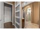 Living room with hardwood floors, modern barn doors, and access to ensuite bathroom at 25971 W Taro Dr, Buckeye, AZ 85396