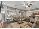 Spacious living room with hardwood floors, large sectional sofa, and natural light at 25971 W Taro Dr, Buckeye, AZ 85396
