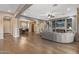 Spacious living room boasts wood floors, fireplace, media center, and open access to dining area, creating an inviting space at 25971 W Taro Dr, Buckeye, AZ 85396