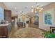 Open-concept living space showcases wood floors, recessed lighting, and seamless transition to kitchen and dining areas at 25971 W Taro Dr, Buckeye, AZ 85396
