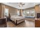 Primary bedroom with hardwood floors, large windows, and a decorative headboard at 25971 W Taro Dr, Buckeye, AZ 85396