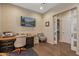 Functional office with mounted TV, desk, and wood floors, perfect for remote work at 25971 W Taro Dr, Buckeye, AZ 85396