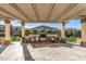 An outdoor kitchen with stone counters, a grill, and a beverage fridge provide everything for entertaining at 25971 W Taro Dr, Buckeye, AZ 85396