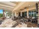 Spacious covered patio boasts comfortable seating, ceiling fans, and travertine flooring for seamless indoor-outdoor living at 25971 W Taro Dr, Buckeye, AZ 85396