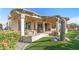 Spacious covered patio with a full outdoor kitchen, dining area, and comfortable lounge seating area at 25971 W Taro Dr, Buckeye, AZ 85396