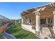 Expansive covered patio with an outdoor kitchen and an additional dining area, all surrounded by well-manicured landscaping at 25971 W Taro Dr, Buckeye, AZ 85396
