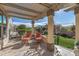 Inviting covered patio with lounge chairs and travertine flooring perfect for enjoying sunny Arizona days at 25971 W Taro Dr, Buckeye, AZ 85396