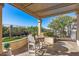 Charming covered patio with seating for four, providing a serene spot for outdoor dining and relaxing at 25971 W Taro Dr, Buckeye, AZ 85396