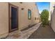 Side view of a tan house with a dark brown door at 25971 W Taro Dr, Buckeye, AZ 85396