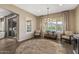 Bright sitting area features wood floors, plantation shutters, decorous lighting, and access to other living spaces at 25971 W Taro Dr, Buckeye, AZ 85396