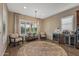 Cozy sitting area with chairs, round rug, and bar area with wine fridge, creating a relaxing space at 25971 W Taro Dr, Buckeye, AZ 85396