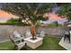 The backyard offers a cozy fire pit area surrounded by comfortable seating, perfect for relaxing evenings at 2619 E Jerome Ave, Mesa, AZ 85204
