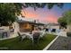 Relax in this backyard oasis with a fire pit, outdoor kitchen, and inviting lounge area by the pool at 2619 E Jerome Ave, Mesa, AZ 85204