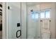Bright bathroom featuring a glass-enclosed shower with modern fixtures and a window for natural light at 2619 E Jerome Ave, Mesa, AZ 85204