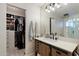 Bathroom featuring custom vanity with drawers, open closet with clothes, and a shower at 2619 E Jerome Ave, Mesa, AZ 85204