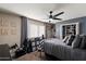 Bedroom boasts neutral walls, plush carpet, a ceiling fan, and a walk-in closet with ample storage at 2619 E Jerome Ave, Mesa, AZ 85204