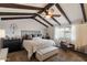 Comfortable bedroom featuring vaulted ceilings with dark wood beams and natural light from the window at 2619 E Jerome Ave, Mesa, AZ 85204