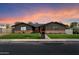 Charming single-story home with a brick accent, green lawn, and beautiful dusk sky at 2619 E Jerome Ave, Mesa, AZ 85204