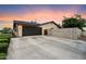 Exterior view of a home showcasing the garage, driveway, and brick wall at 2619 E Jerome Ave, Mesa, AZ 85204