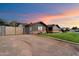 Charming home exterior with manicured lawn, brick accents and gated driveway at 2619 E Jerome Ave, Mesa, AZ 85204
