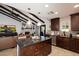 Stylish kitchen with a functional island, dark wood cabinets, and modern appliances, seamlessly connected to the living area at 2619 E Jerome Ave, Mesa, AZ 85204