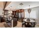Modern kitchen with stainless steel appliances, dark countertops, and an adjacent dining area at 2619 E Jerome Ave, Mesa, AZ 85204